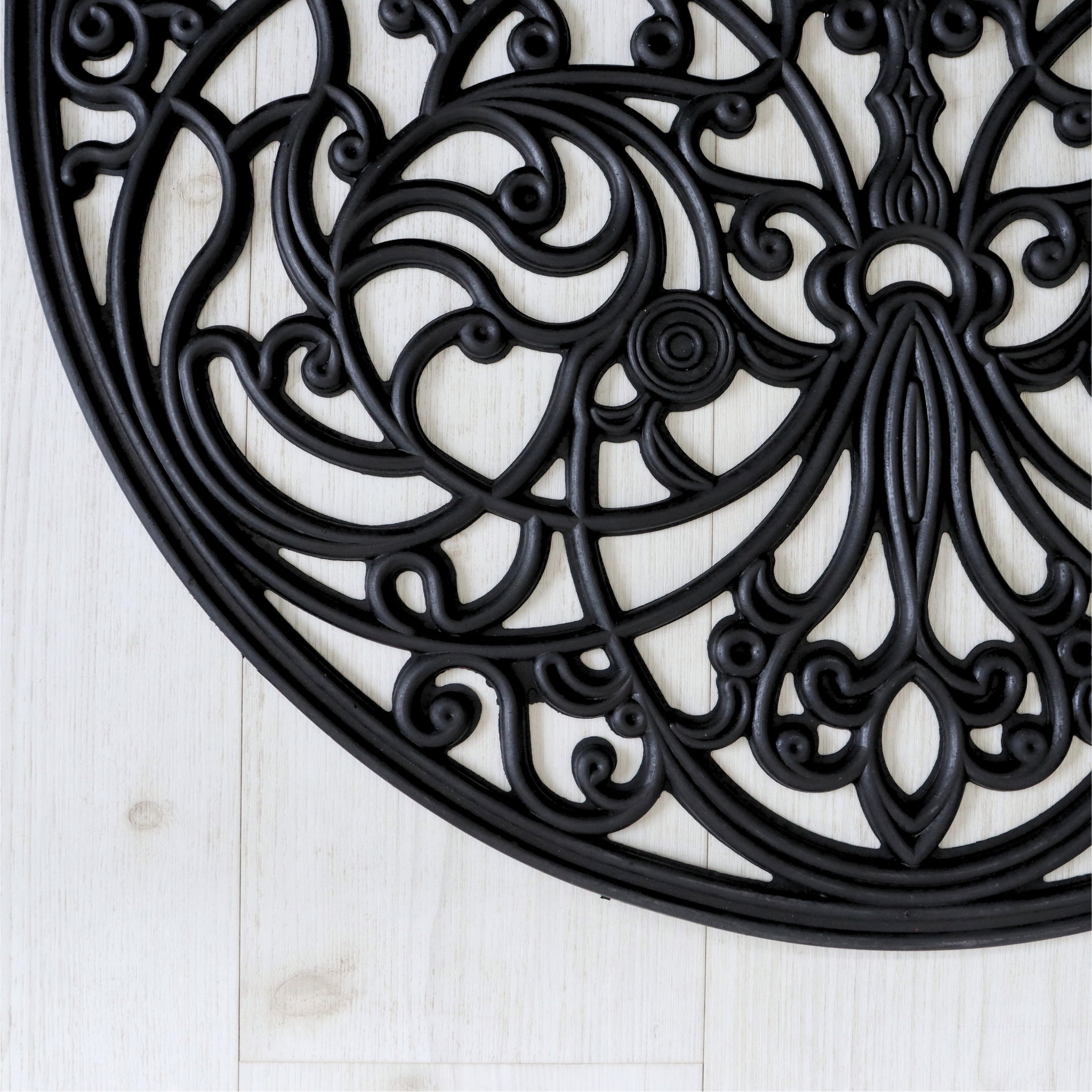 Decorative black rubber door mat white wooden floor