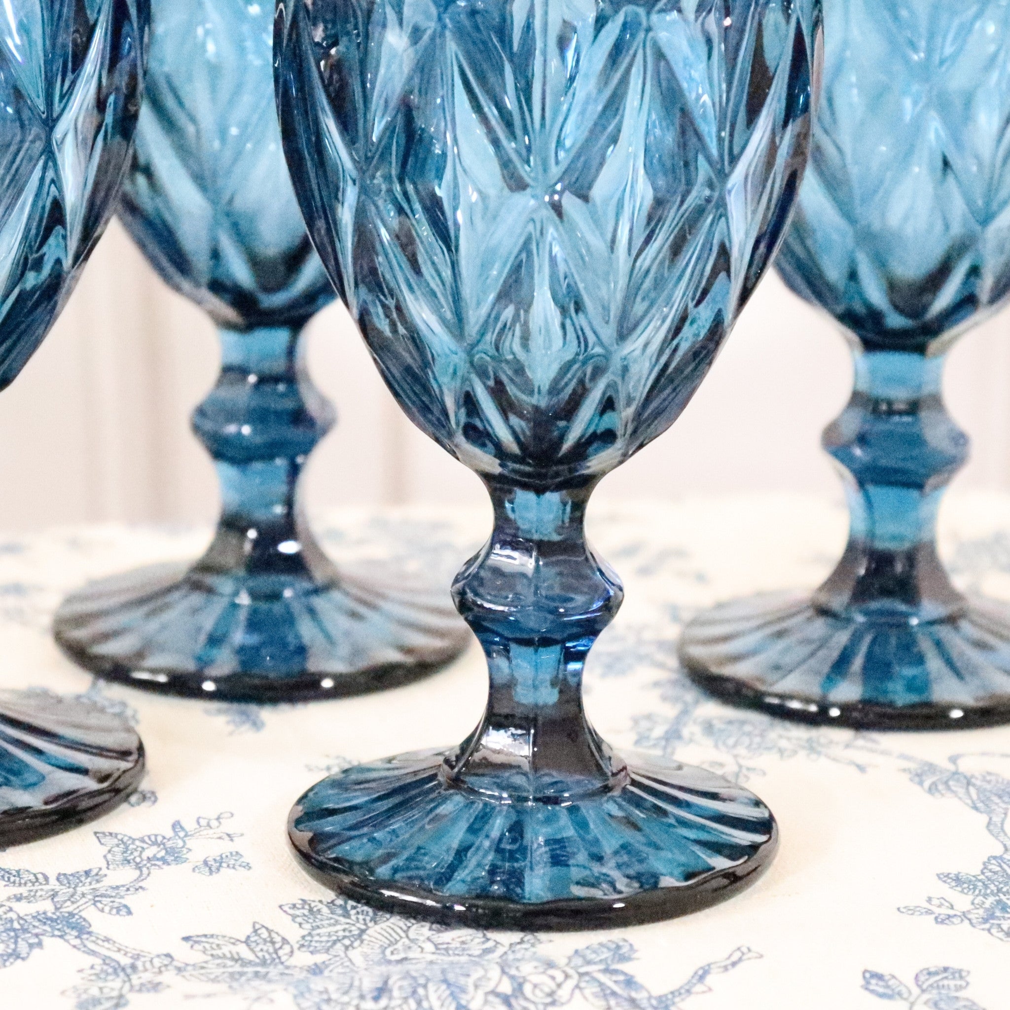 Set of blue crystal goblets on a decorative tablecloth