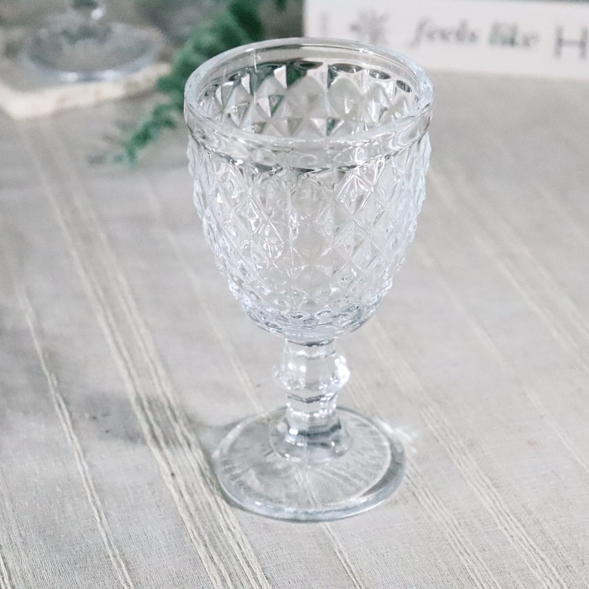 Clear glass goblet on a textured surface