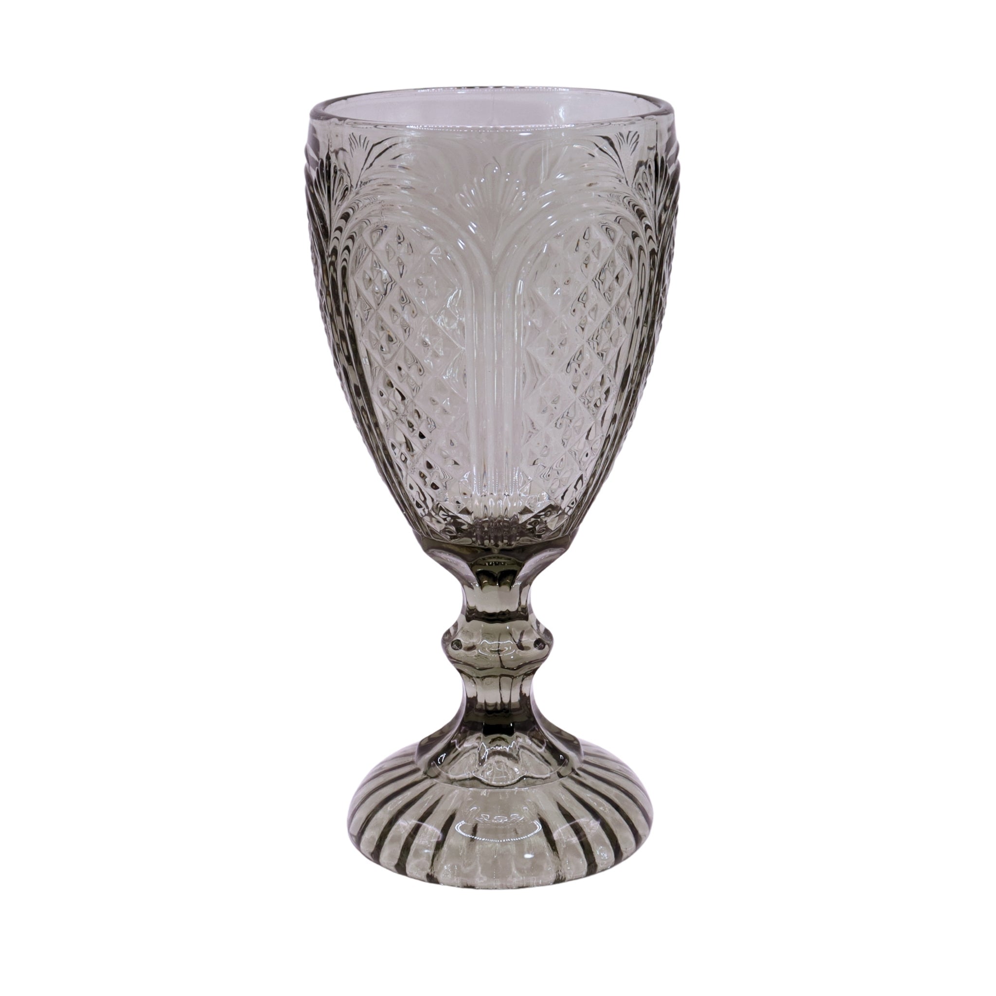Decorative glass goblet with intricate patterns on a white background