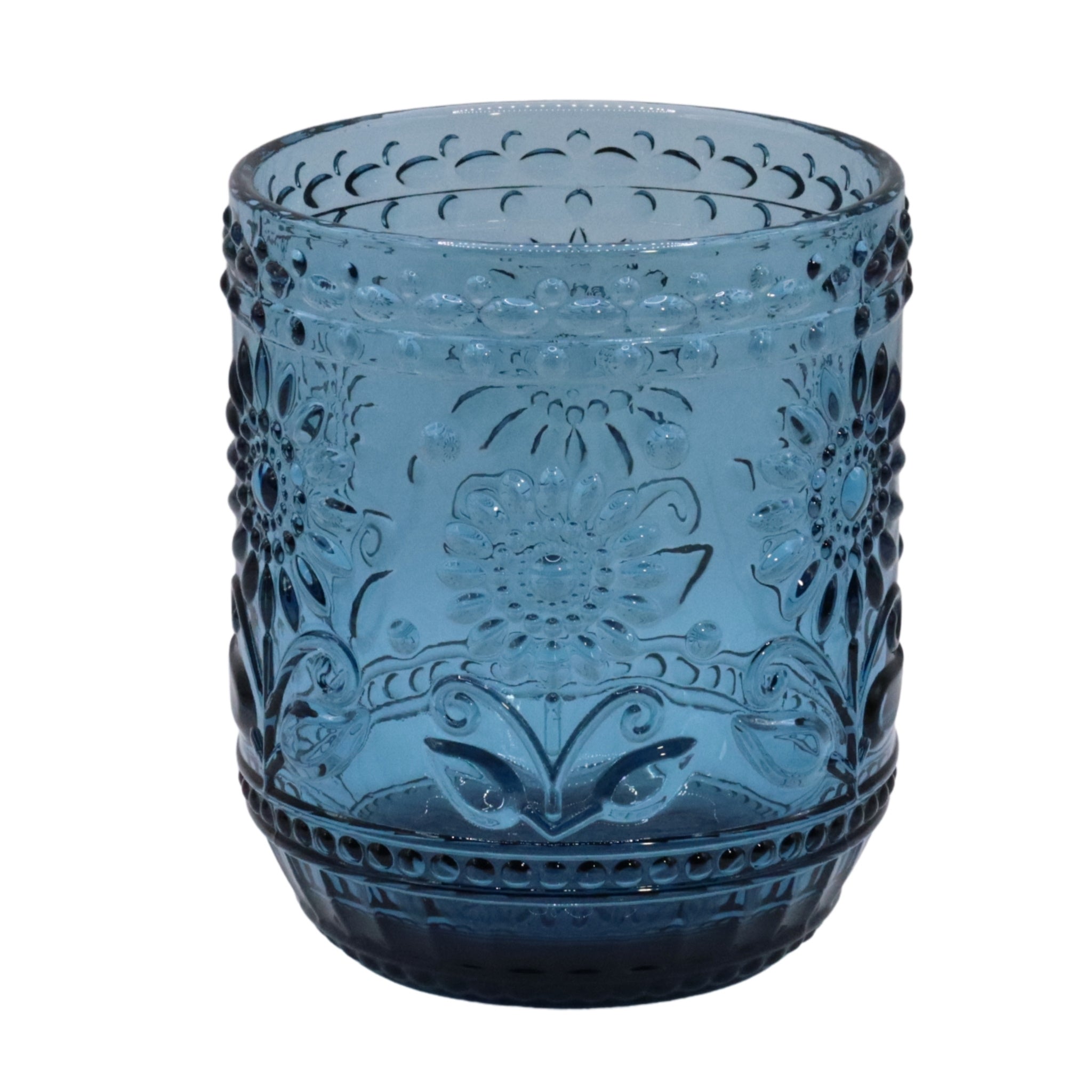 Blue glass tumbler with decorative patterns on a white background