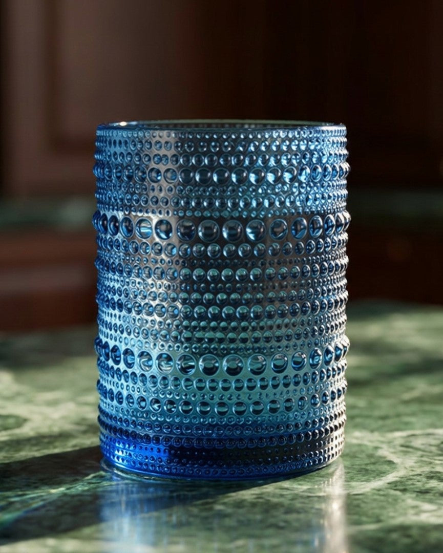 blue textured glass tumblers on a marble surface