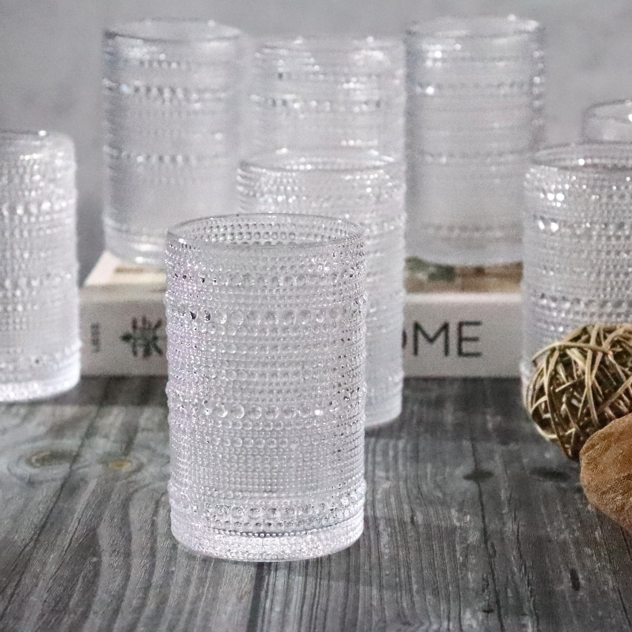 Clear jupiter beaded hobnail with decorative patterns on a wooden surface