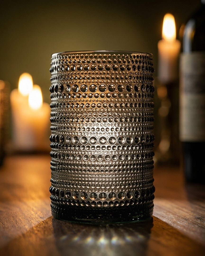 Set of hobnail jupiter bead glass grey tumblers on a wooden surface with a marble background