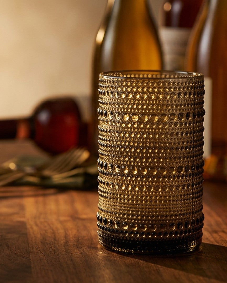 Set of hobnail jupiter bead glass tumblers on a wooden surface with a light gray background