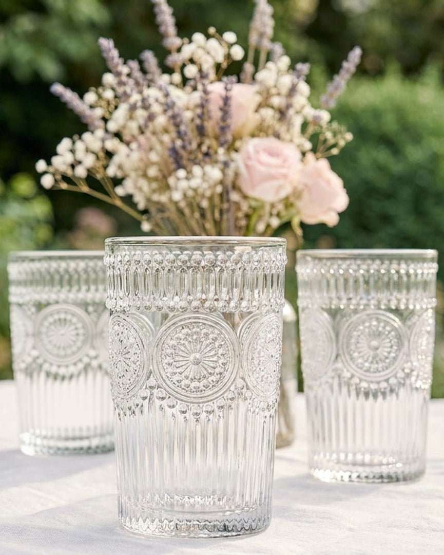 Decorative clear glass tumblers on a wooden surface