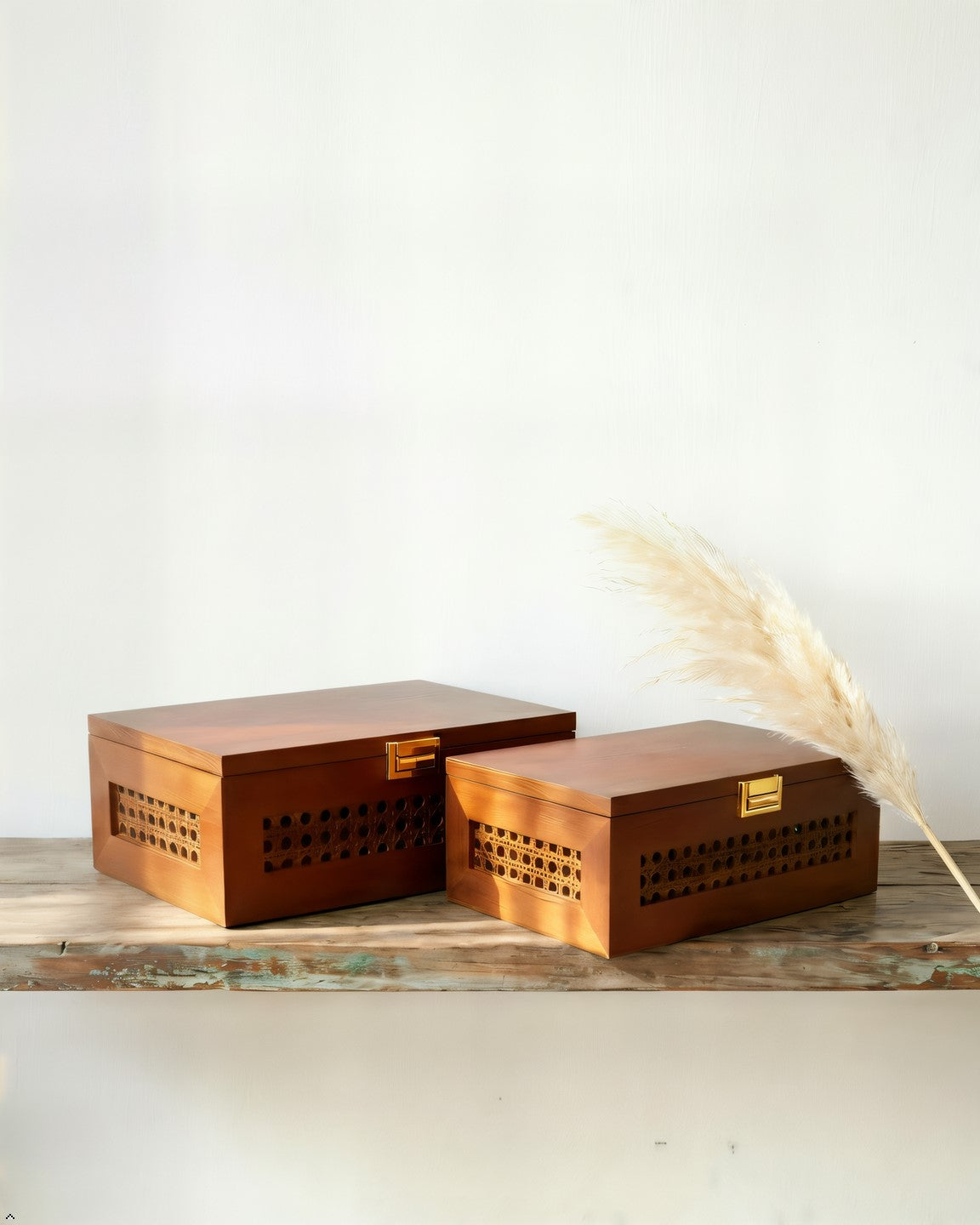 Wooden storage boxes with decorative patterns on a light surface.