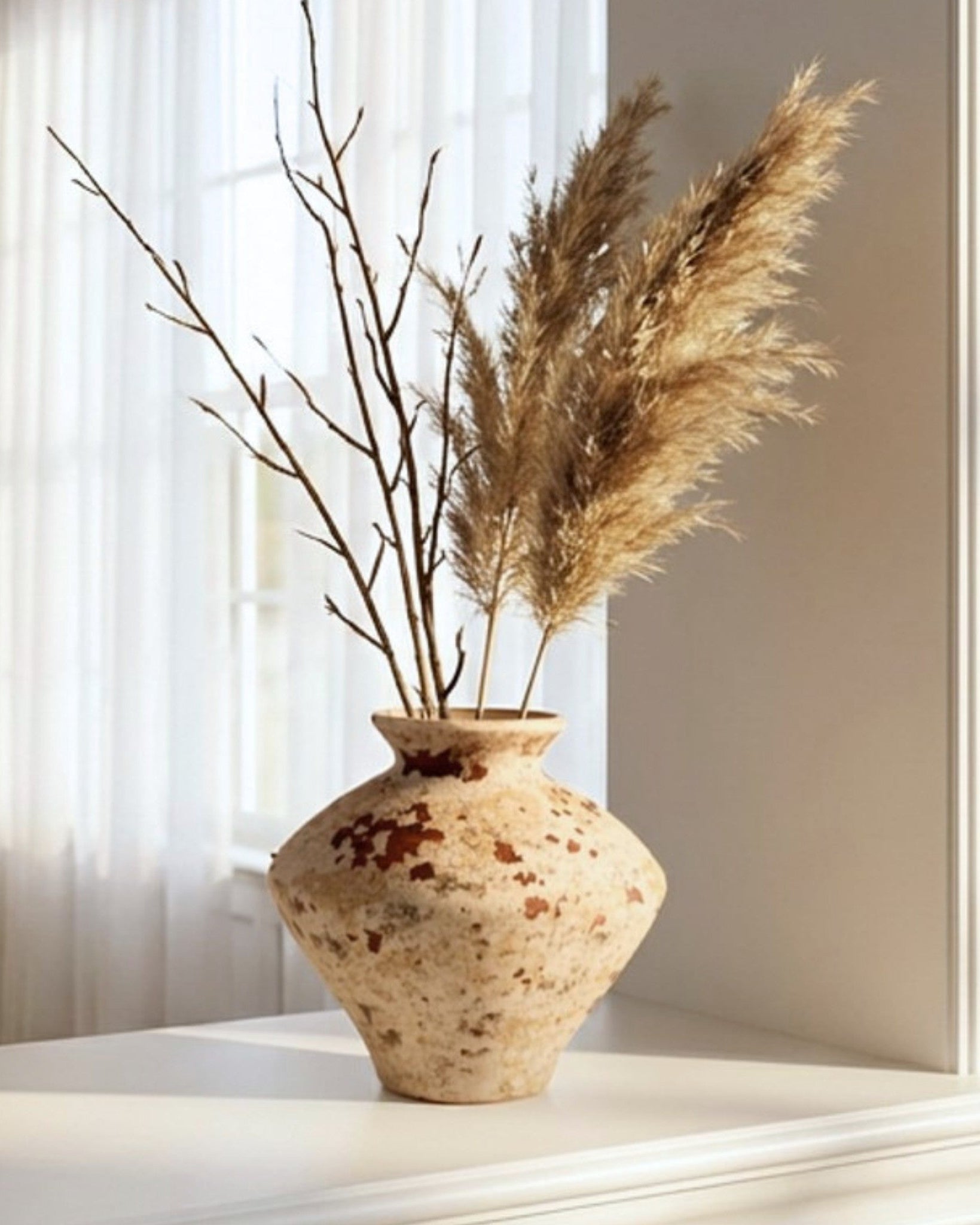Decorative vase with pampas grass on a windowsill