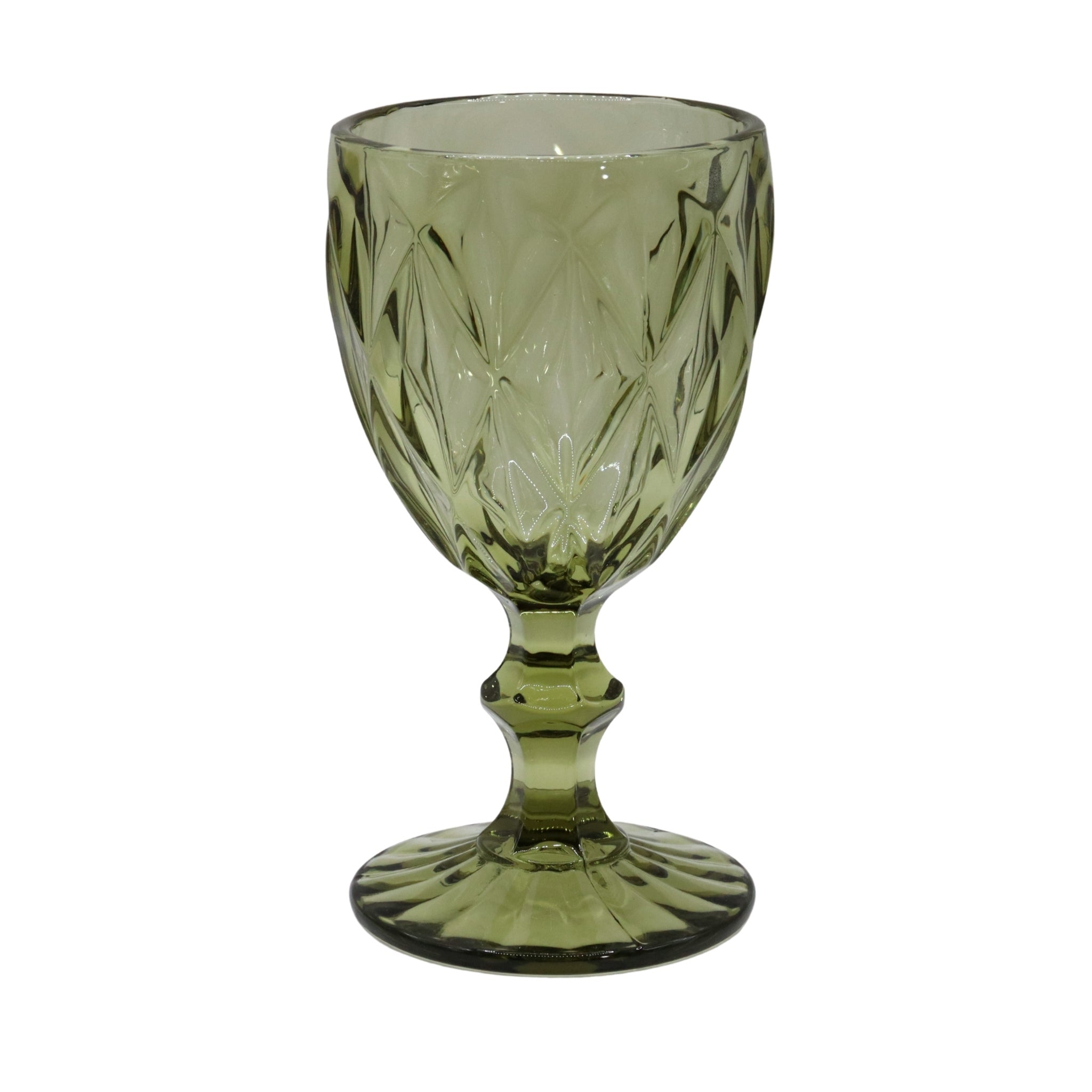Green glass goblet with cut patterns on a white background