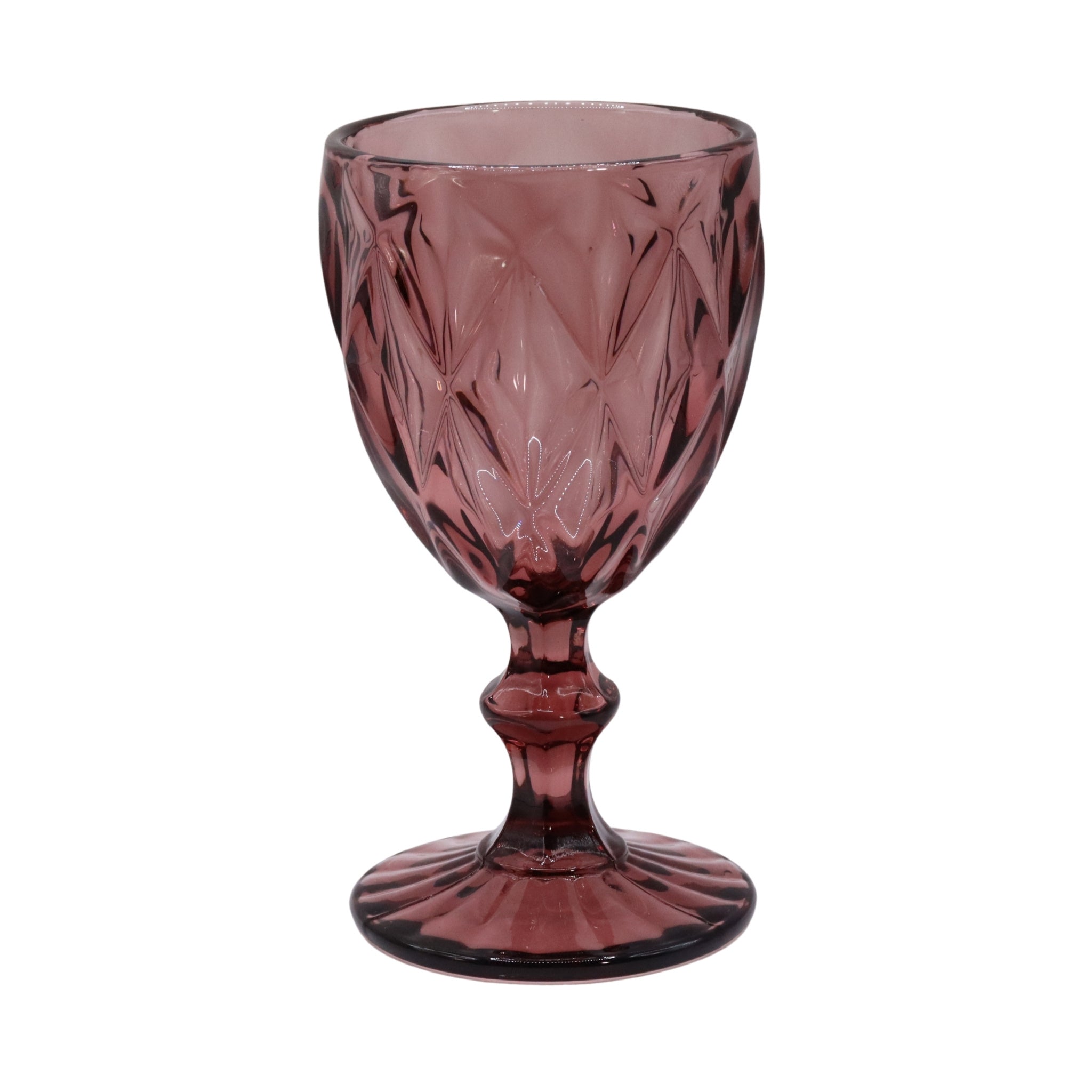 Pink glass goblet with intricate cut patterns on a white background