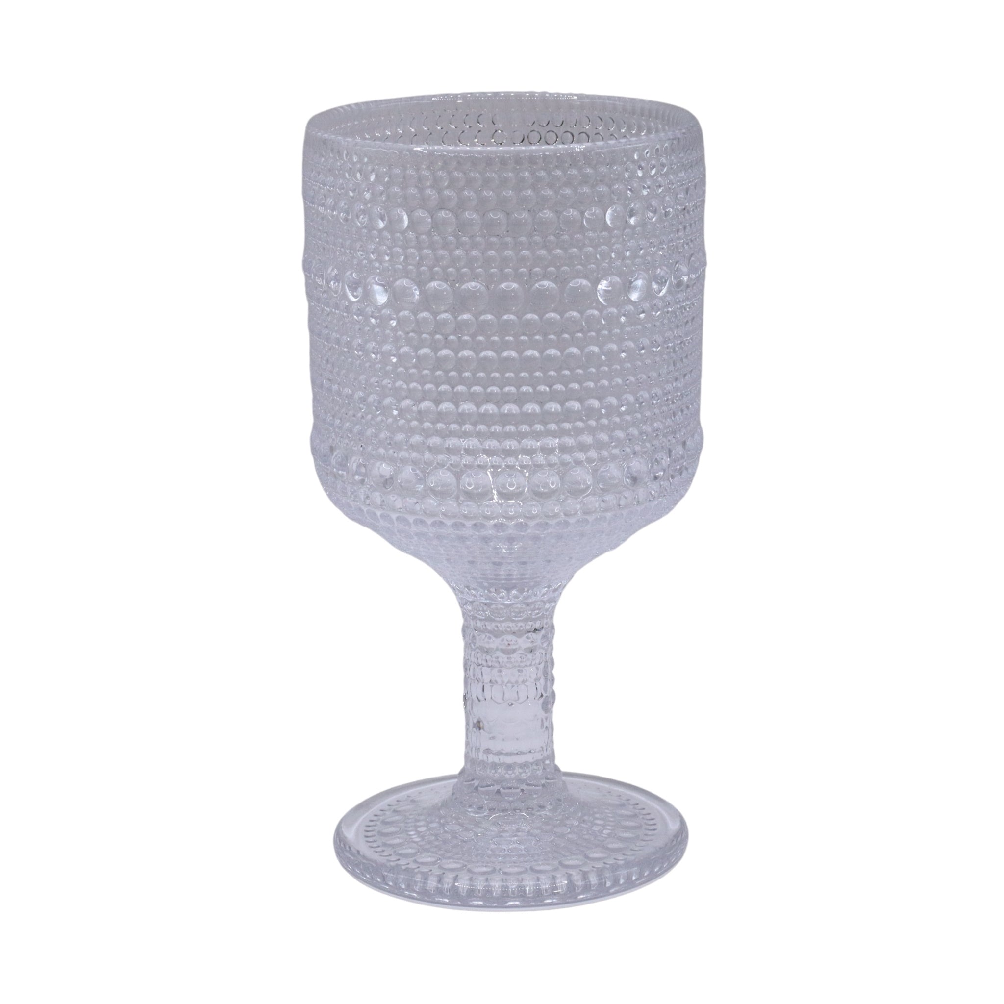 Clear textured glass goblet on a white background