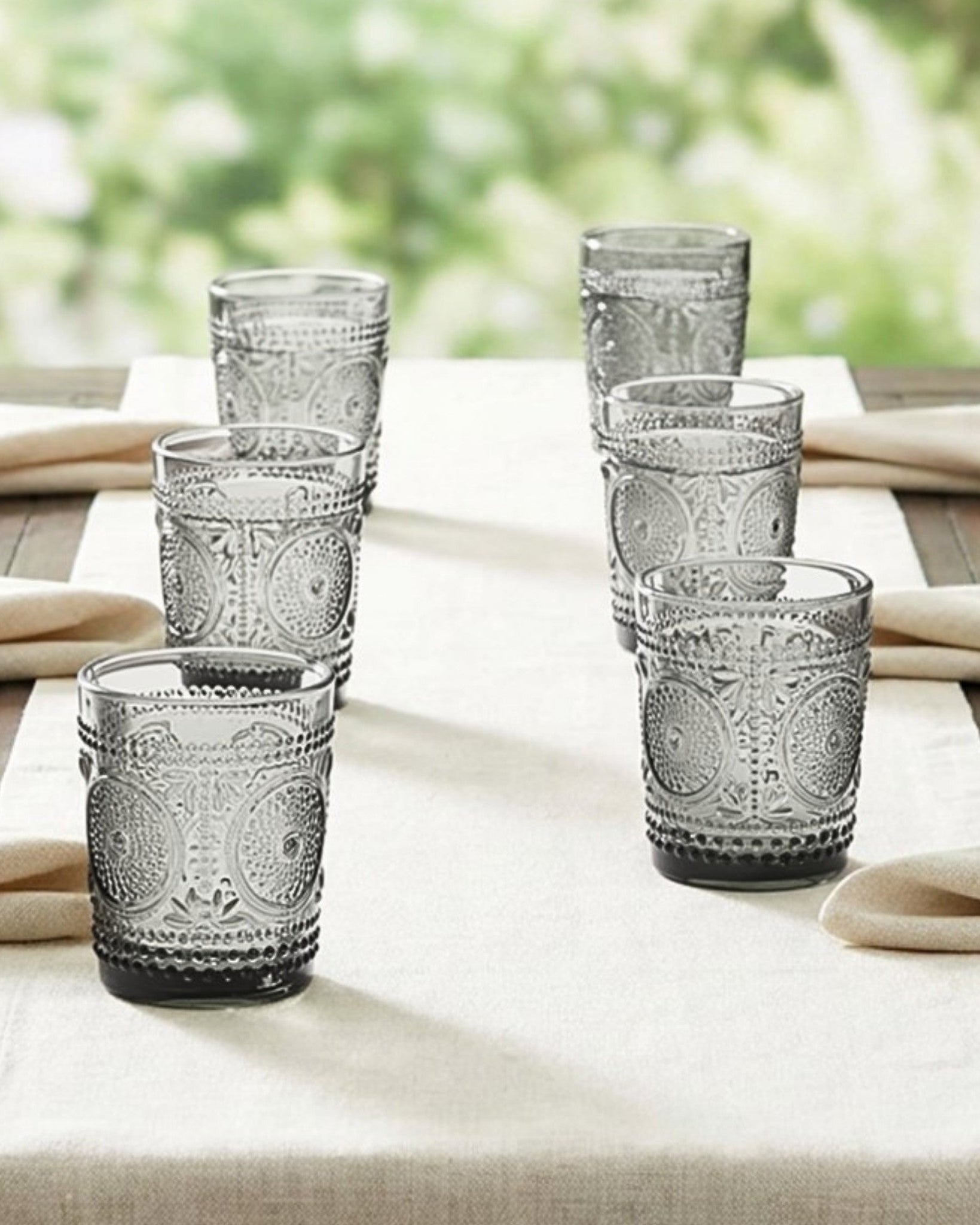 Set of textured glass tumblers on a white surface