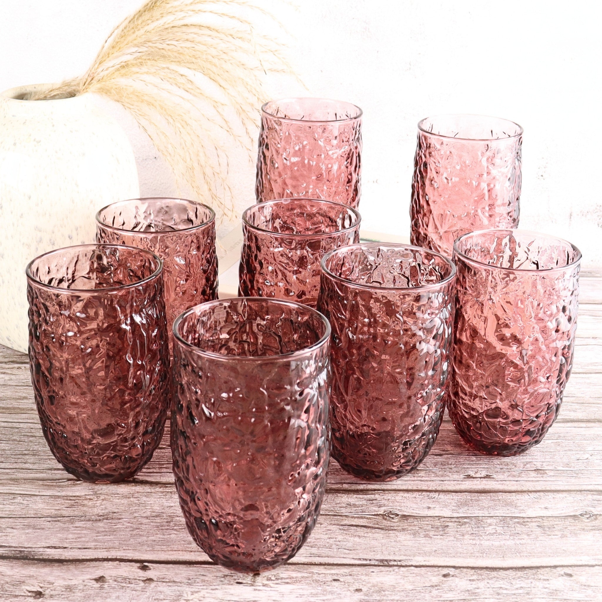 Set of 8 purple textured glass tumblers on a wooden surface