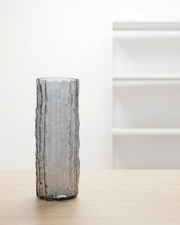 Decorative vase with textured surface on a wooden surface