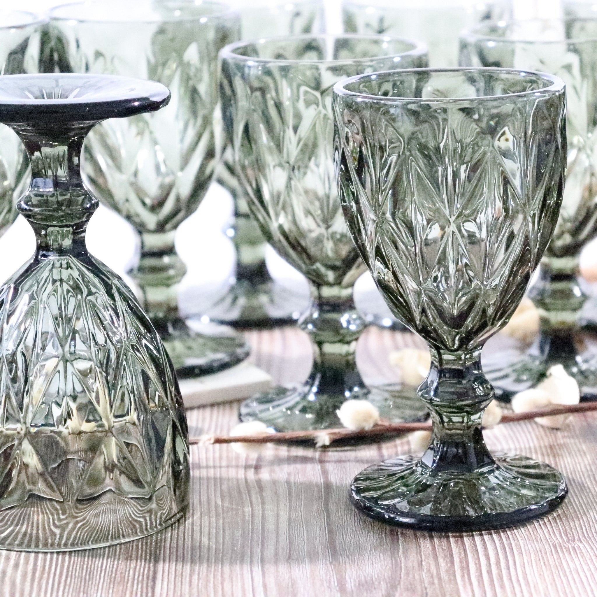 Set of grey glass goblets on a wooden surface