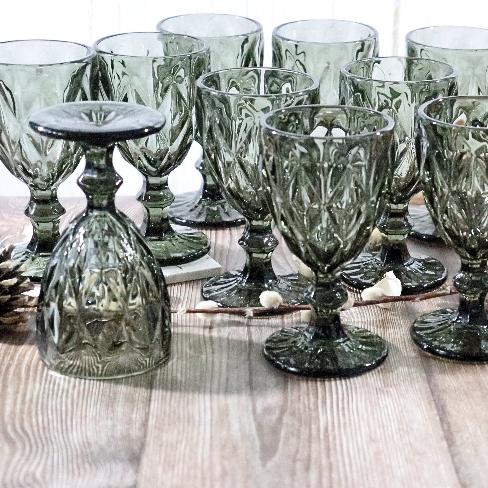 Set of grey glass goblets on a wooden surface