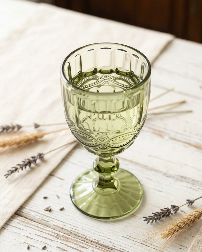 Green glass on a wooden table with lavender and wheat stalks