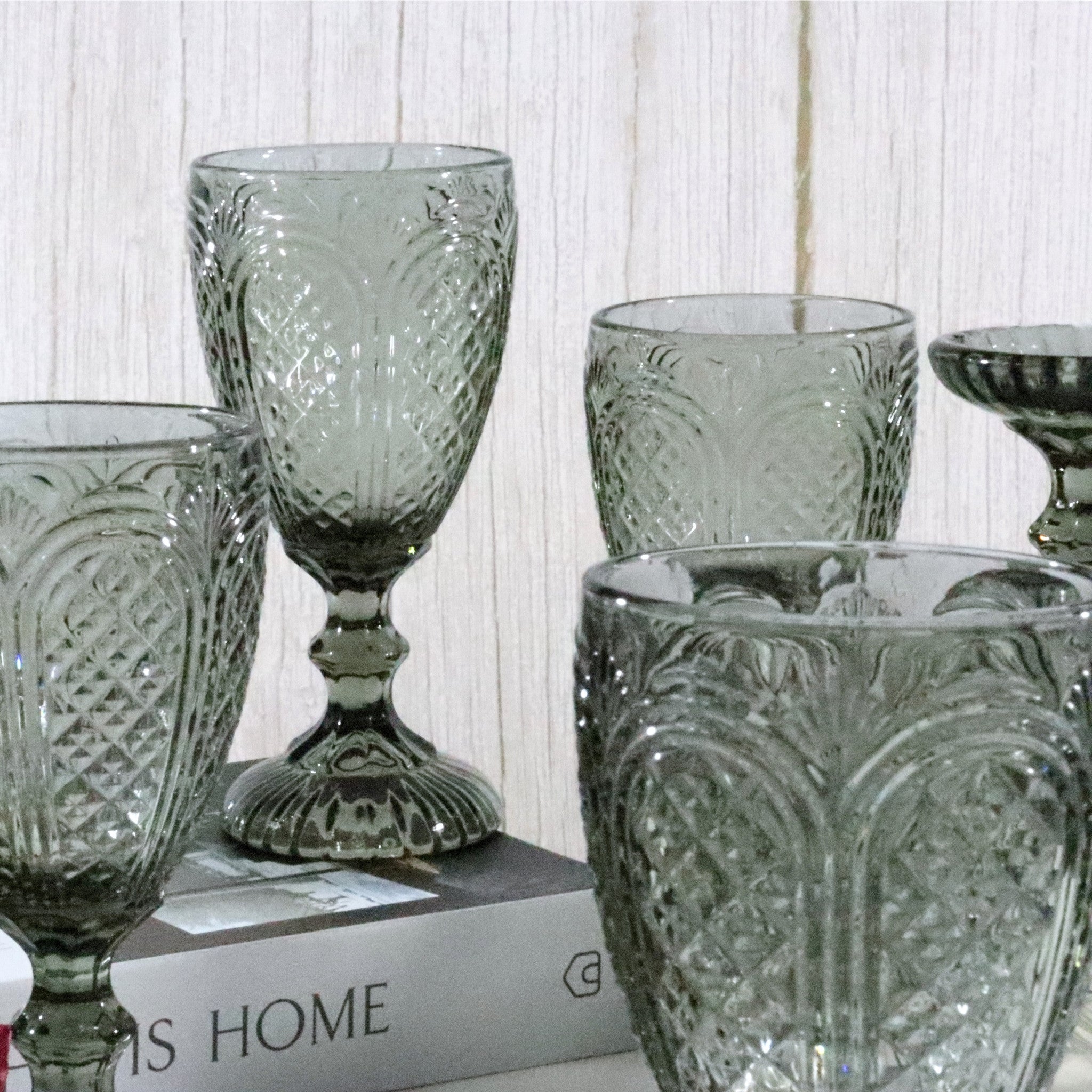 Set of patterned grey glassware on a white surface branding.