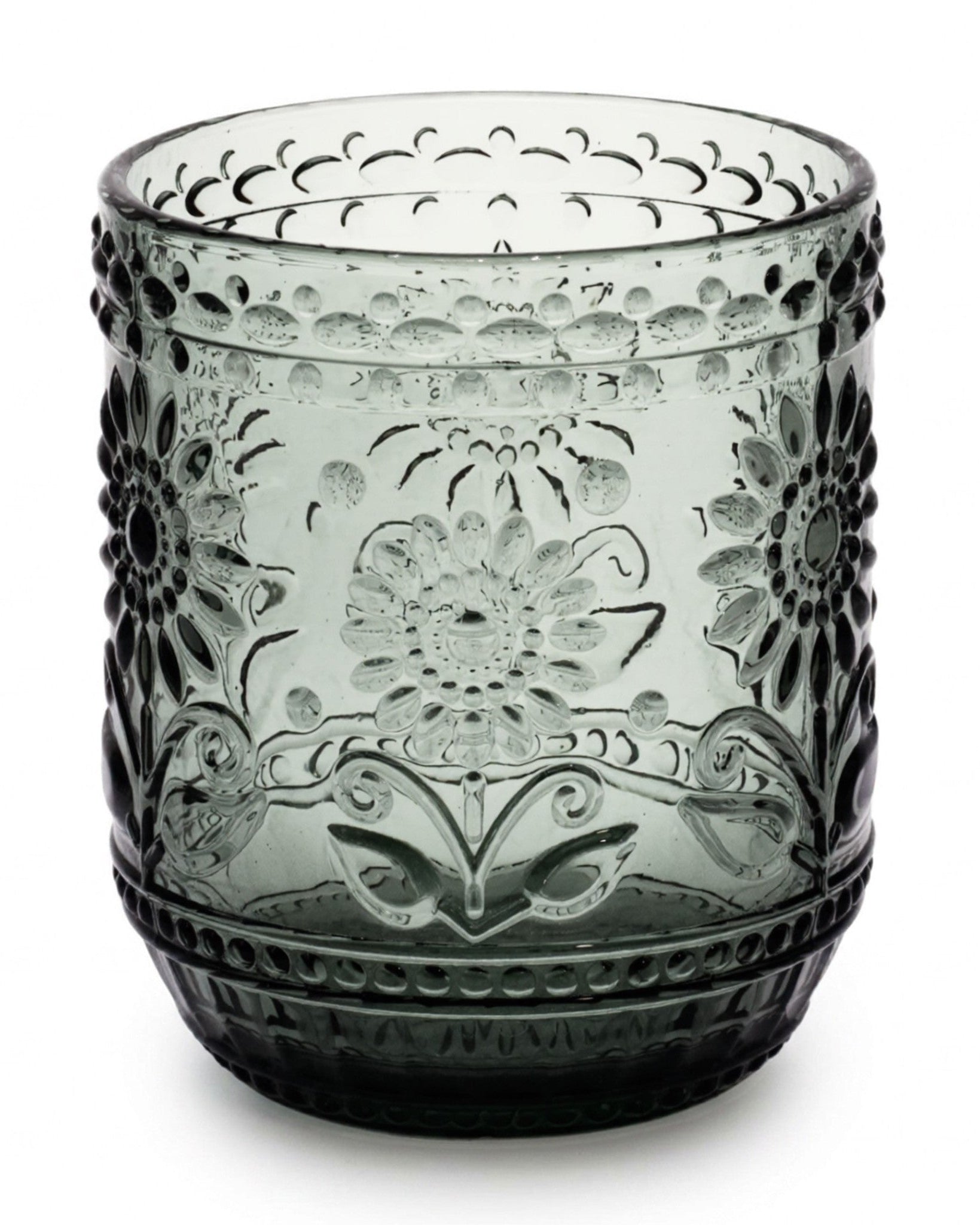 Decorative glass tumbler with floral patterns on a white background