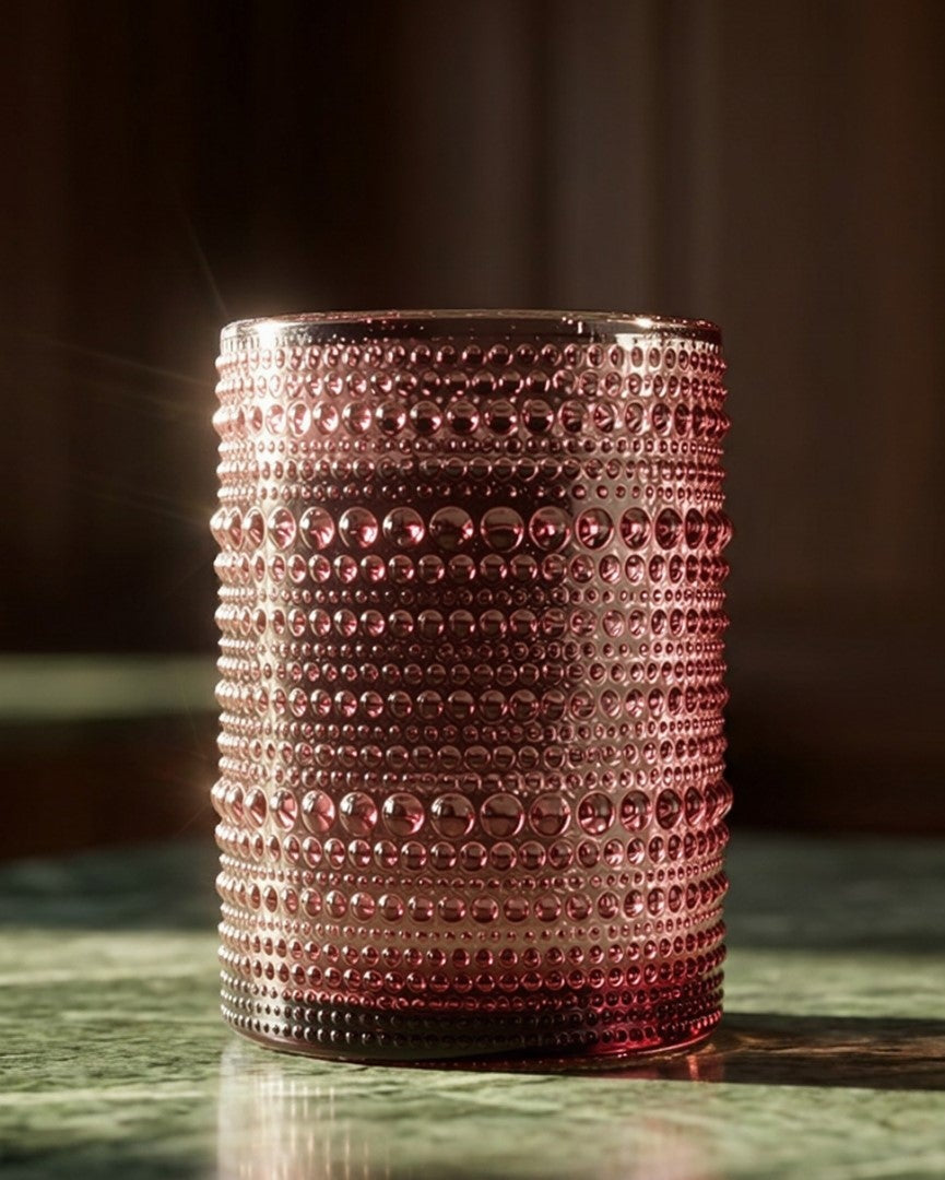 Decorative glass with a textured pattern on a green surface