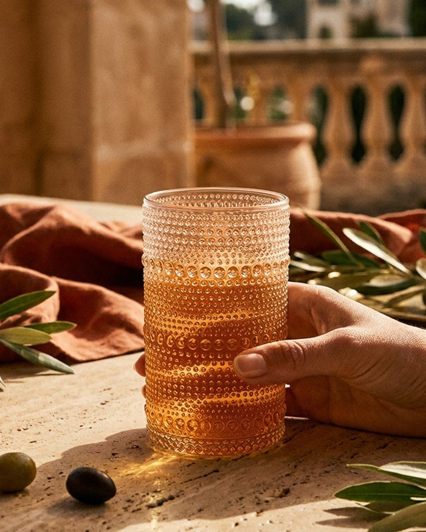 Set of jupiter beaded hobnail glass tumblers on a wooden surface with a neutral background