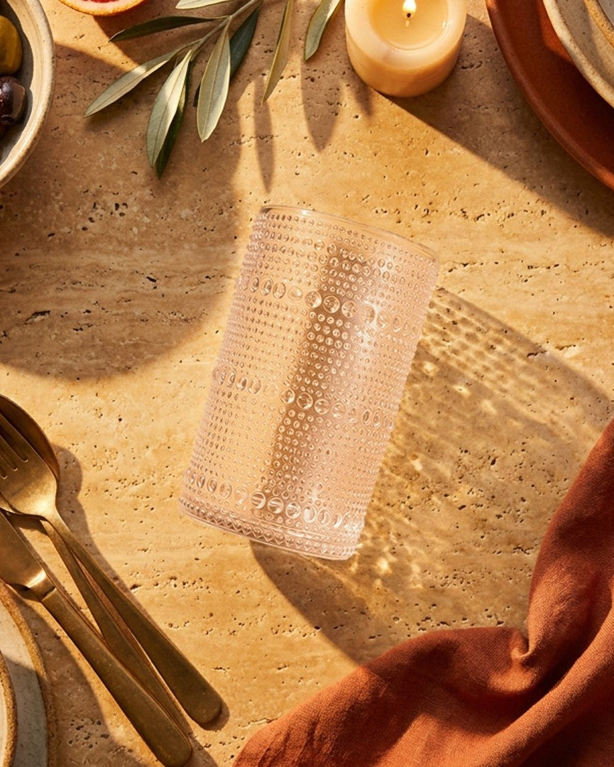 Set of clear beaded hobnail glass tumblers on a wooden stand with 'feels like HOME' sign, against a light gray background.