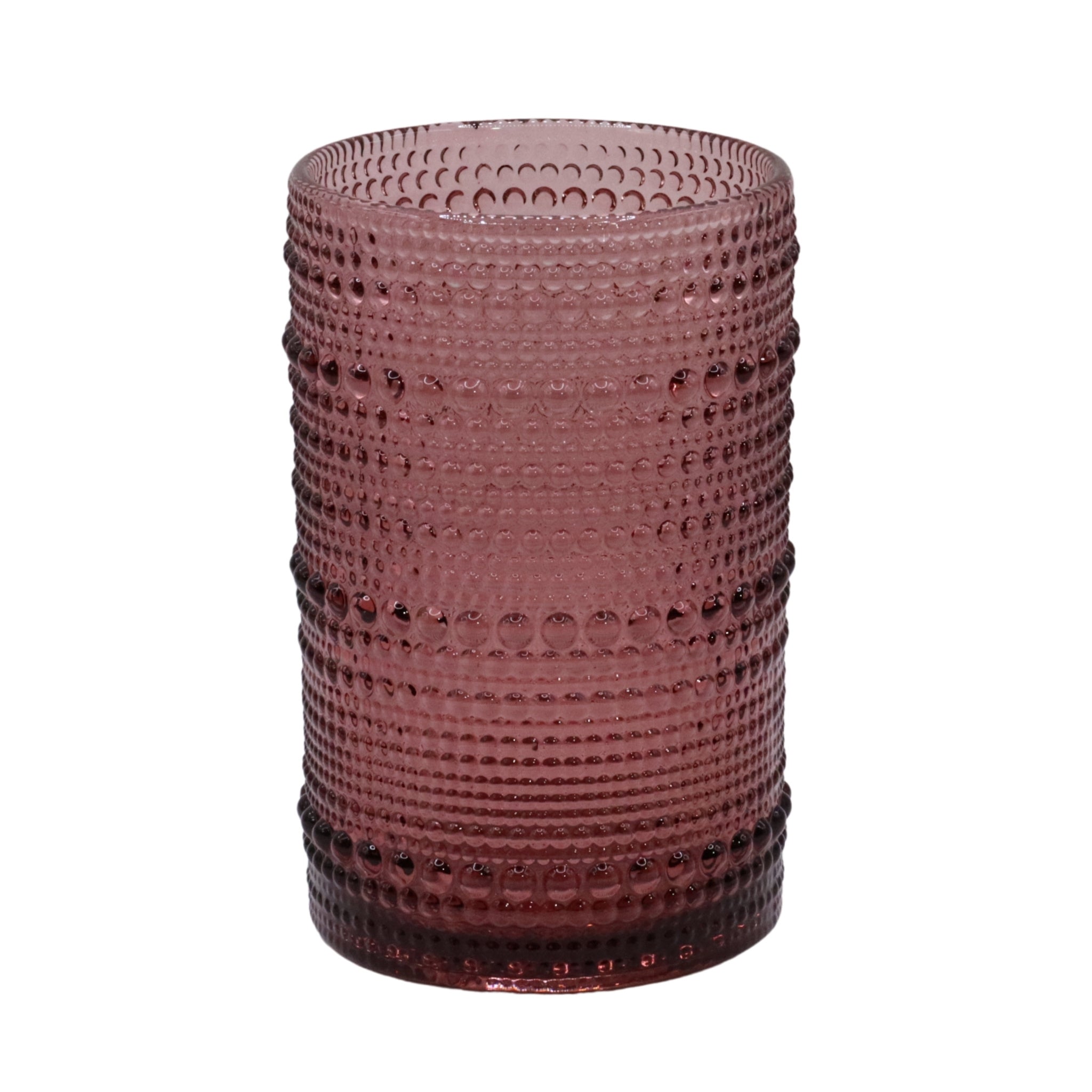 Pink hobnail glass tumbler on a white background