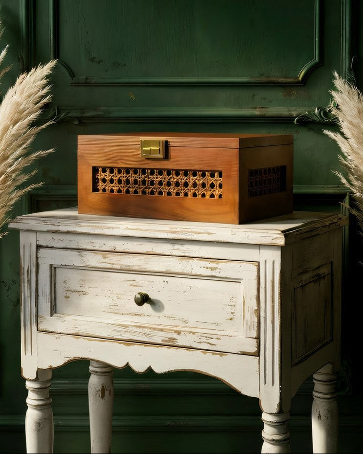 Wooden storage box with dried flowers on a wooden table in a living room.