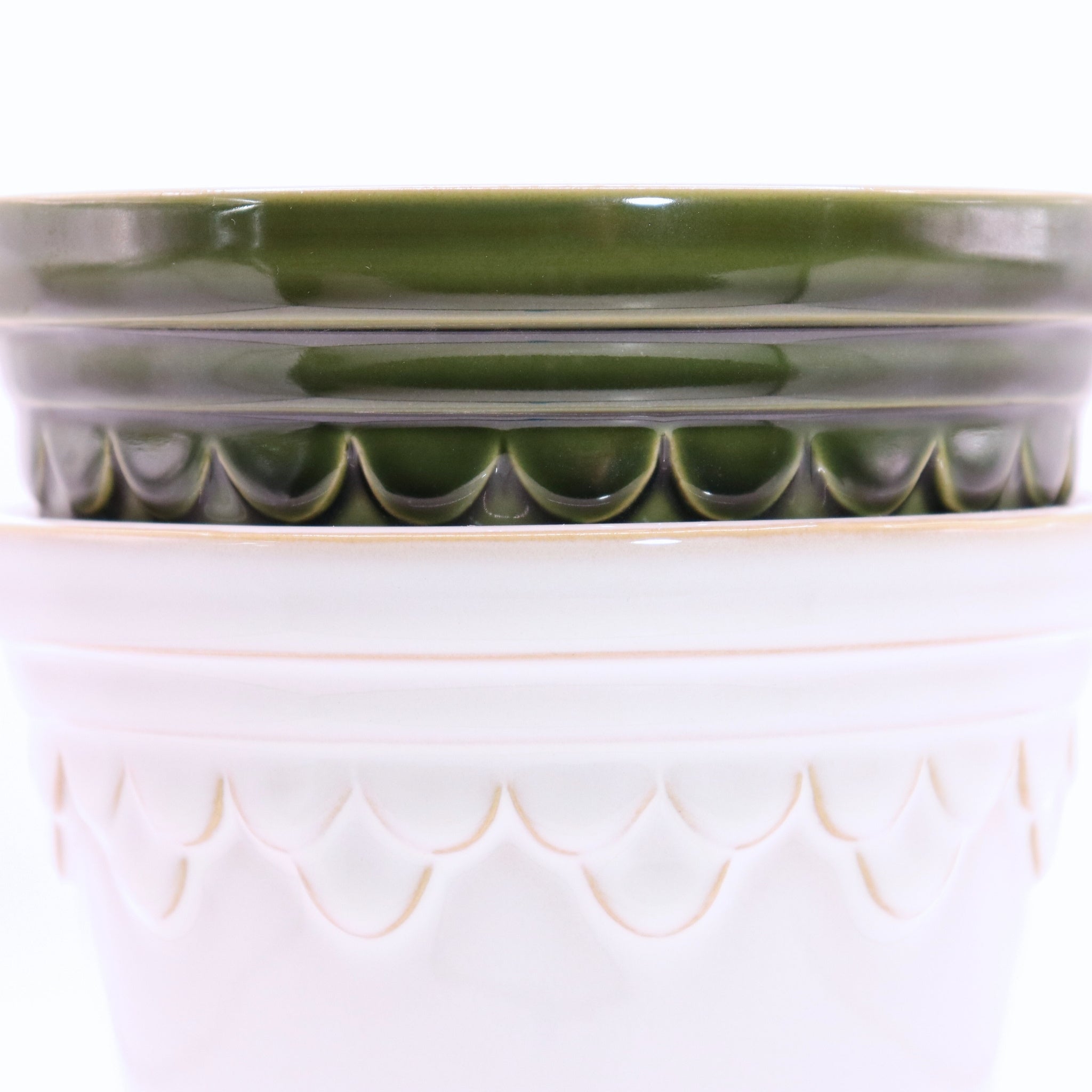 Ceramic planter with green top and beige bottom on a white background