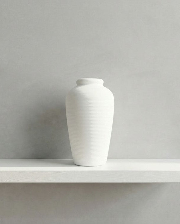 White vase on a shelf 
