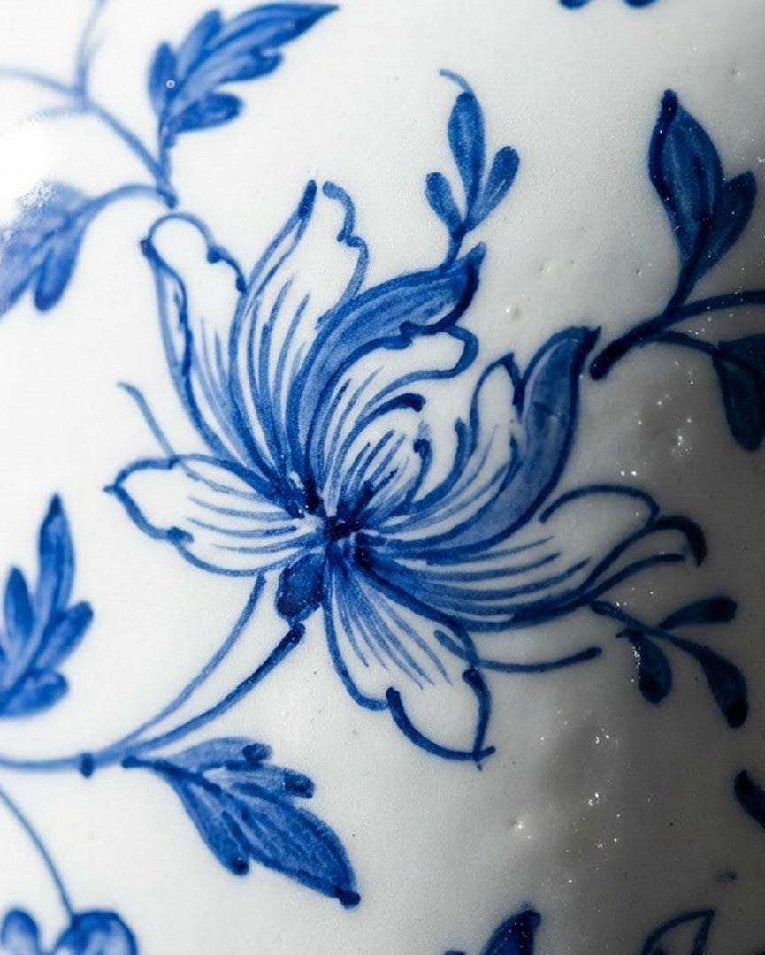 Close-up of blue floral design on white ceramic surface
