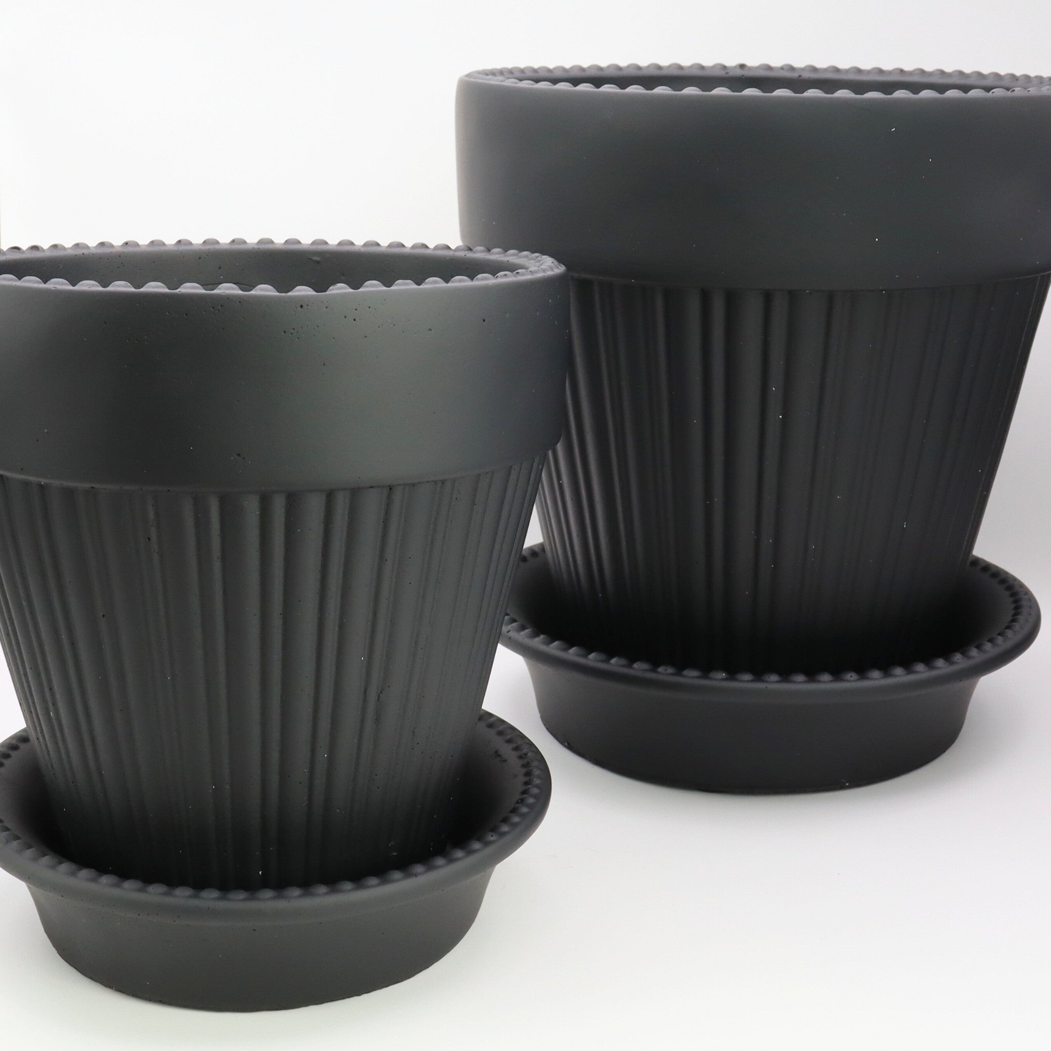 Close-up of a black plant pot on a white background
