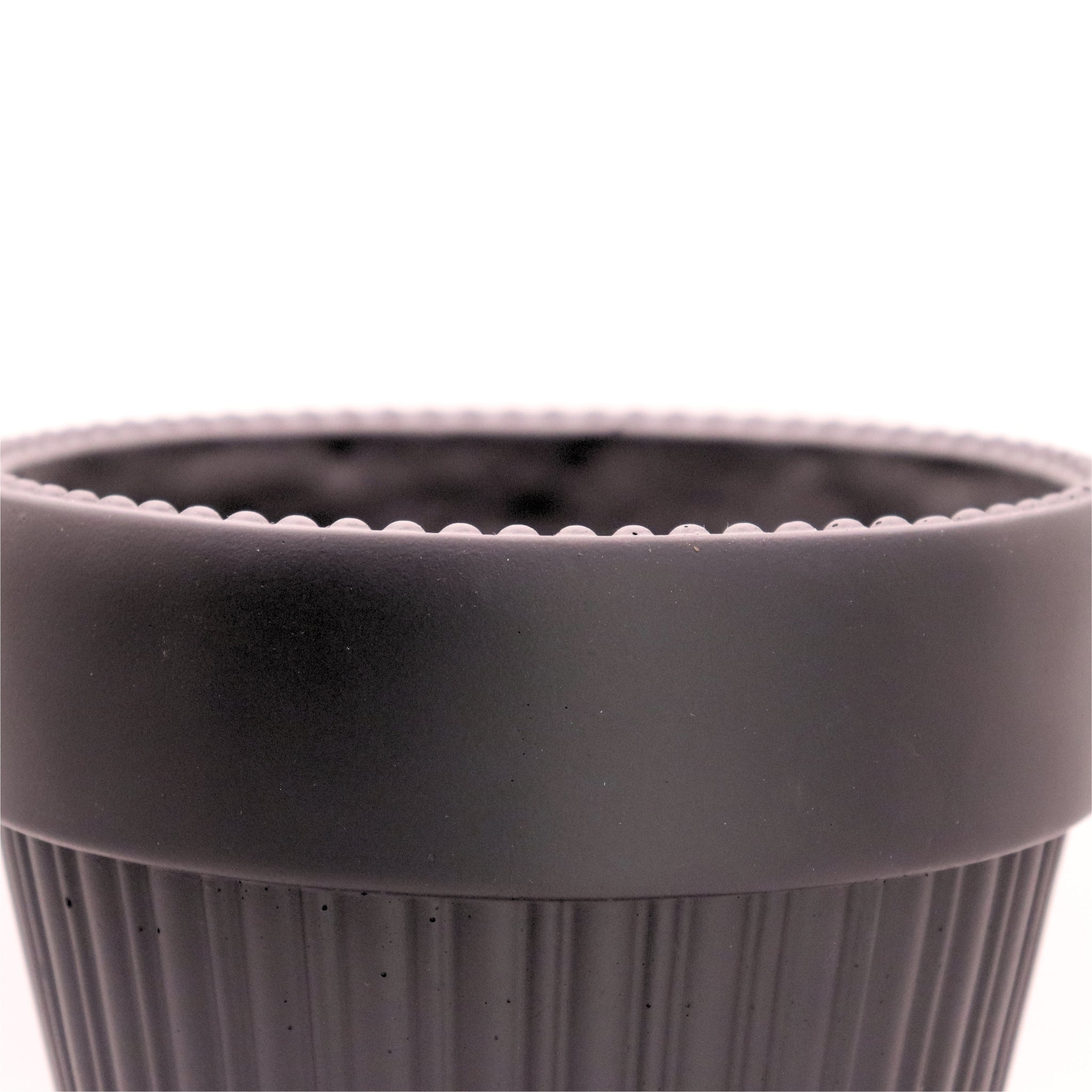 Close-up of a black plant pot on a white background