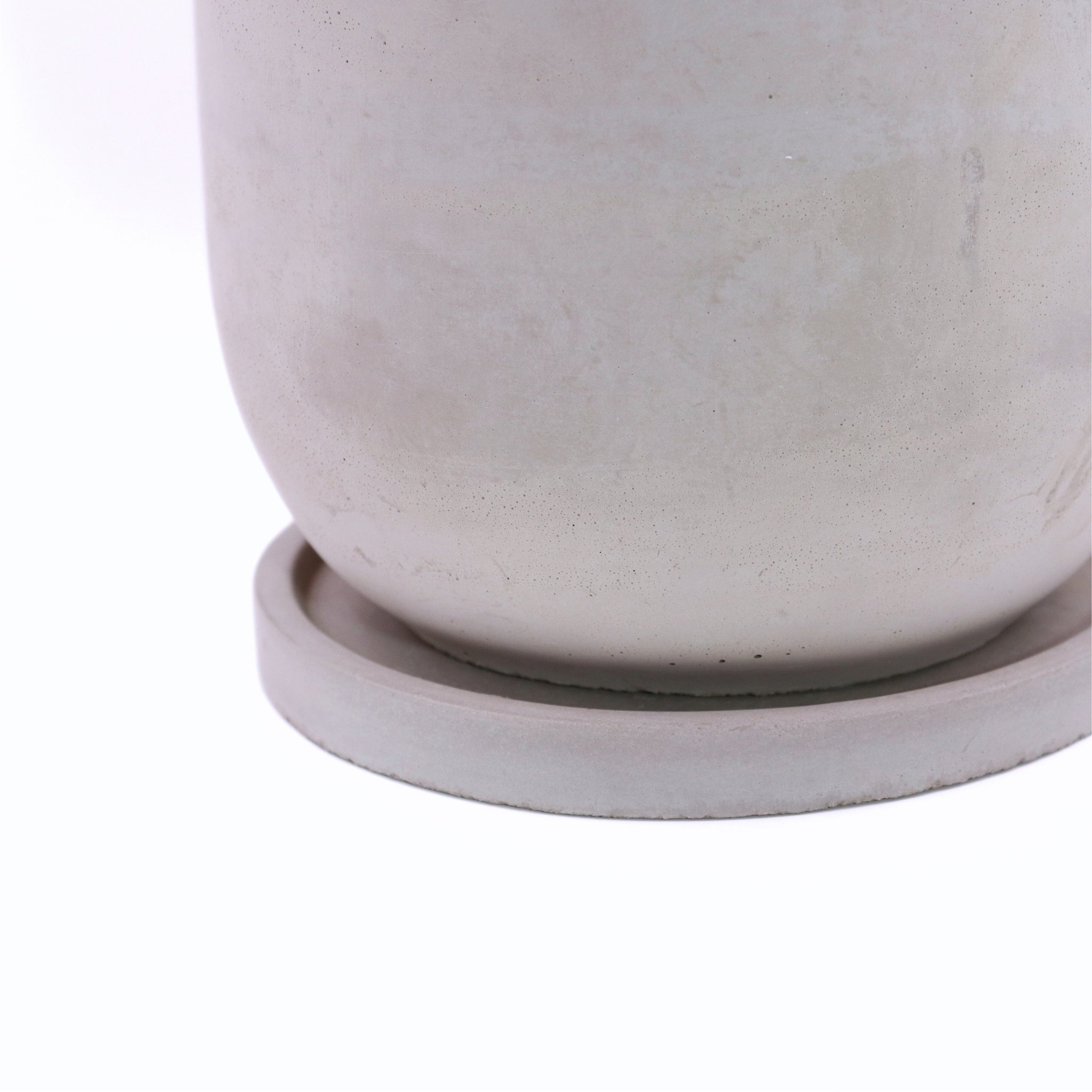 Close-up of a light gray ceramic planter on a white background