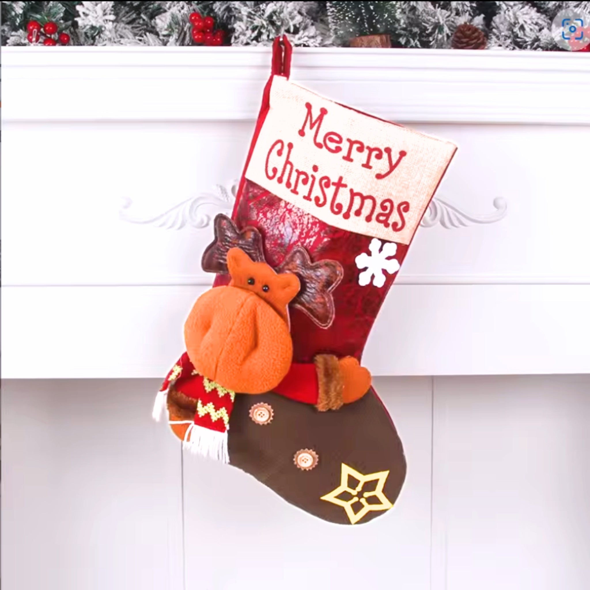 Red Christmas stocking with 'Merry Christmas' text, fox decoration, and star pattern on a white background.