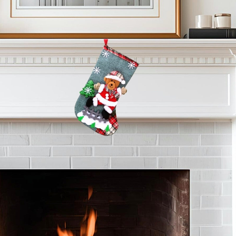 Decorative Christmas stocking with a teddy bear design hanging above a fireplace.