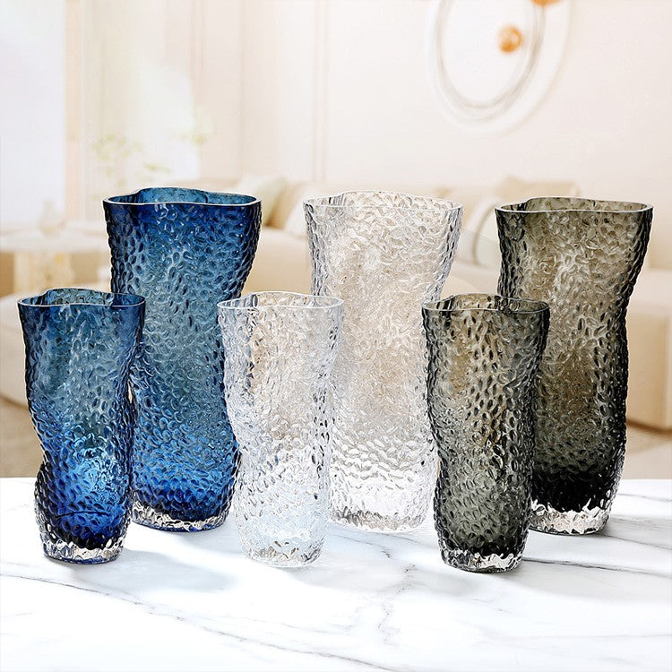 collection of blue, clear and grey glass vases