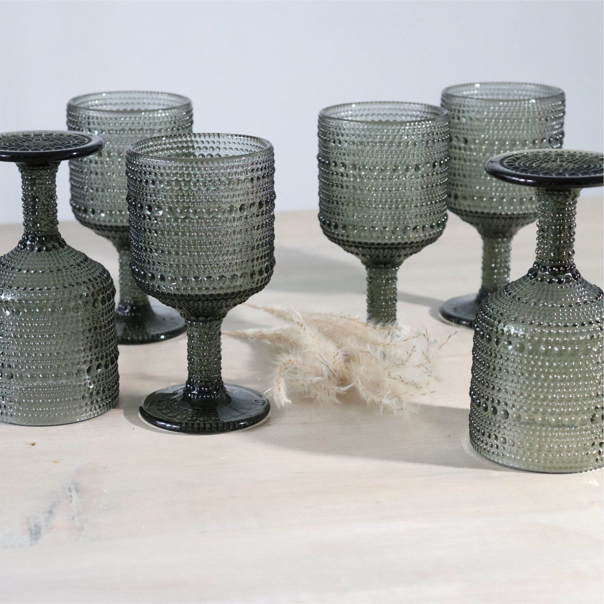 Set of textured glass goblets on a light background