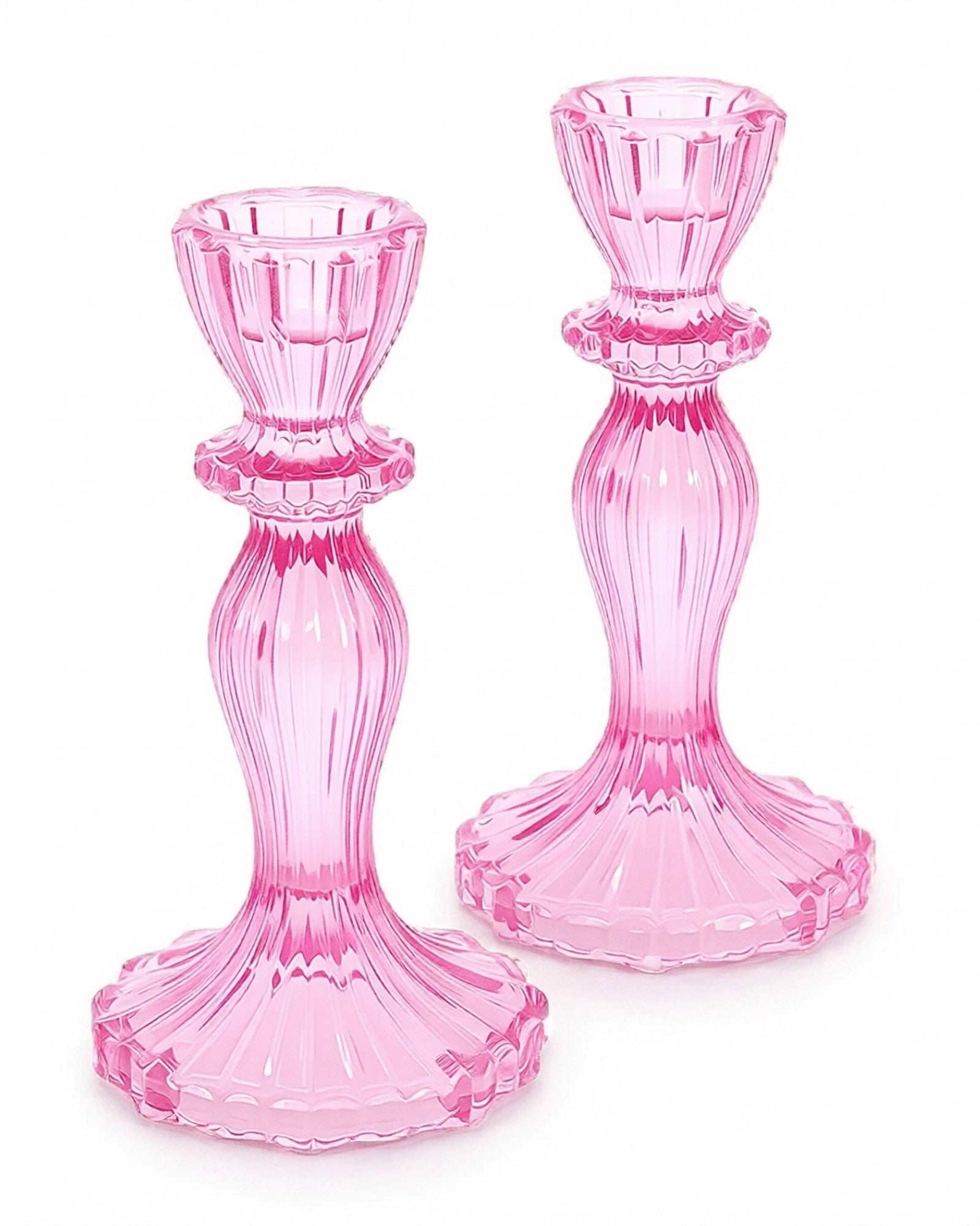 Two pink glass candle holders on a white background