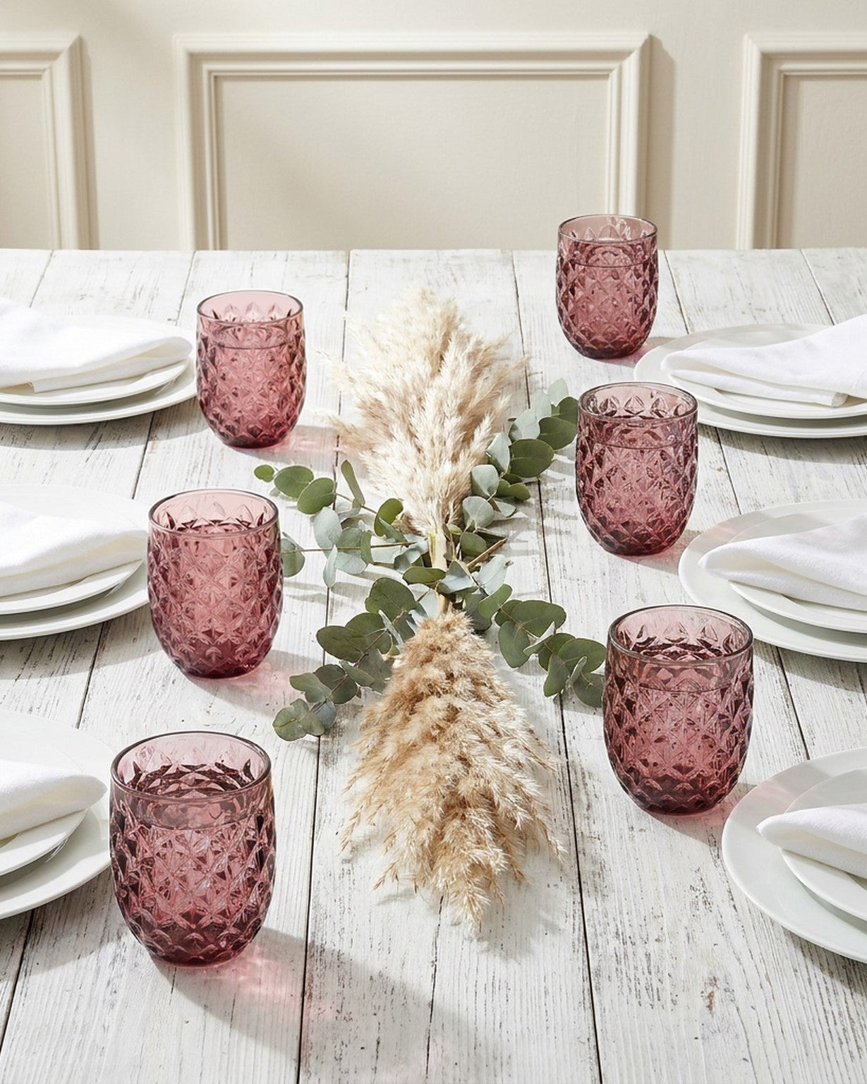 Set of purple textured glass tumblers on a light background