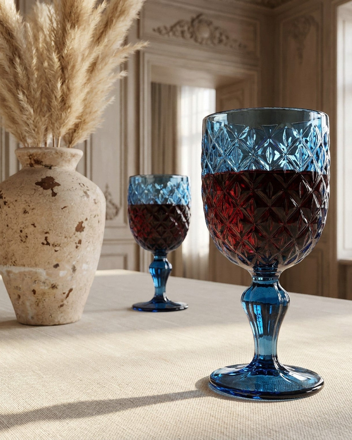 Set of 6 blue glass goblets with textured design on a light gray background