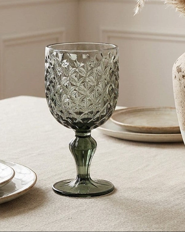 Set of 8 grey patterned glass goblets on a light background