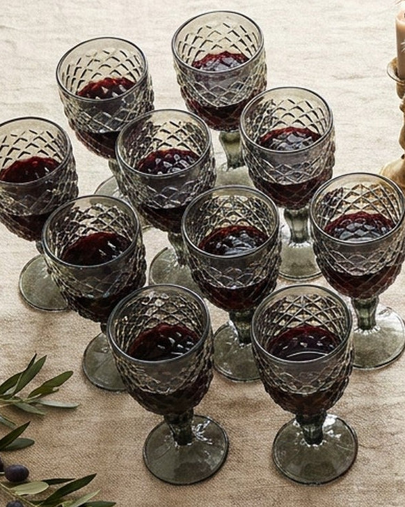 Decorative glass goblet with intricate patterns on a marble surface