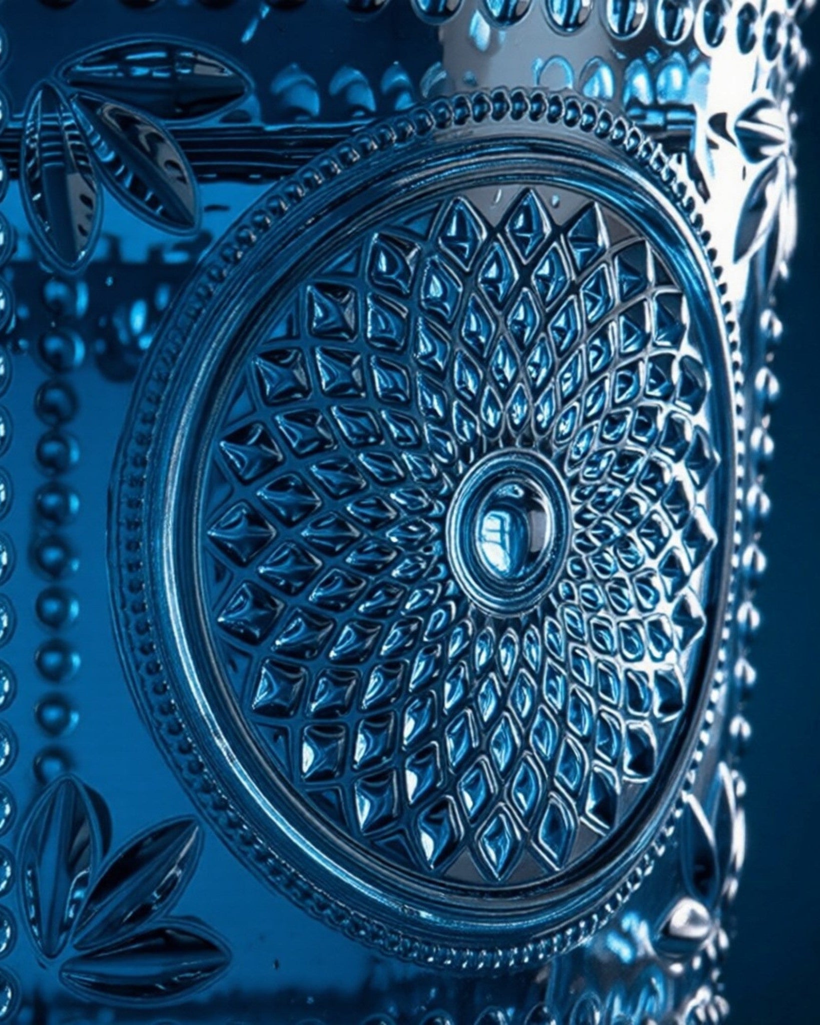 Set of blue textured glass tumblers on a white surface