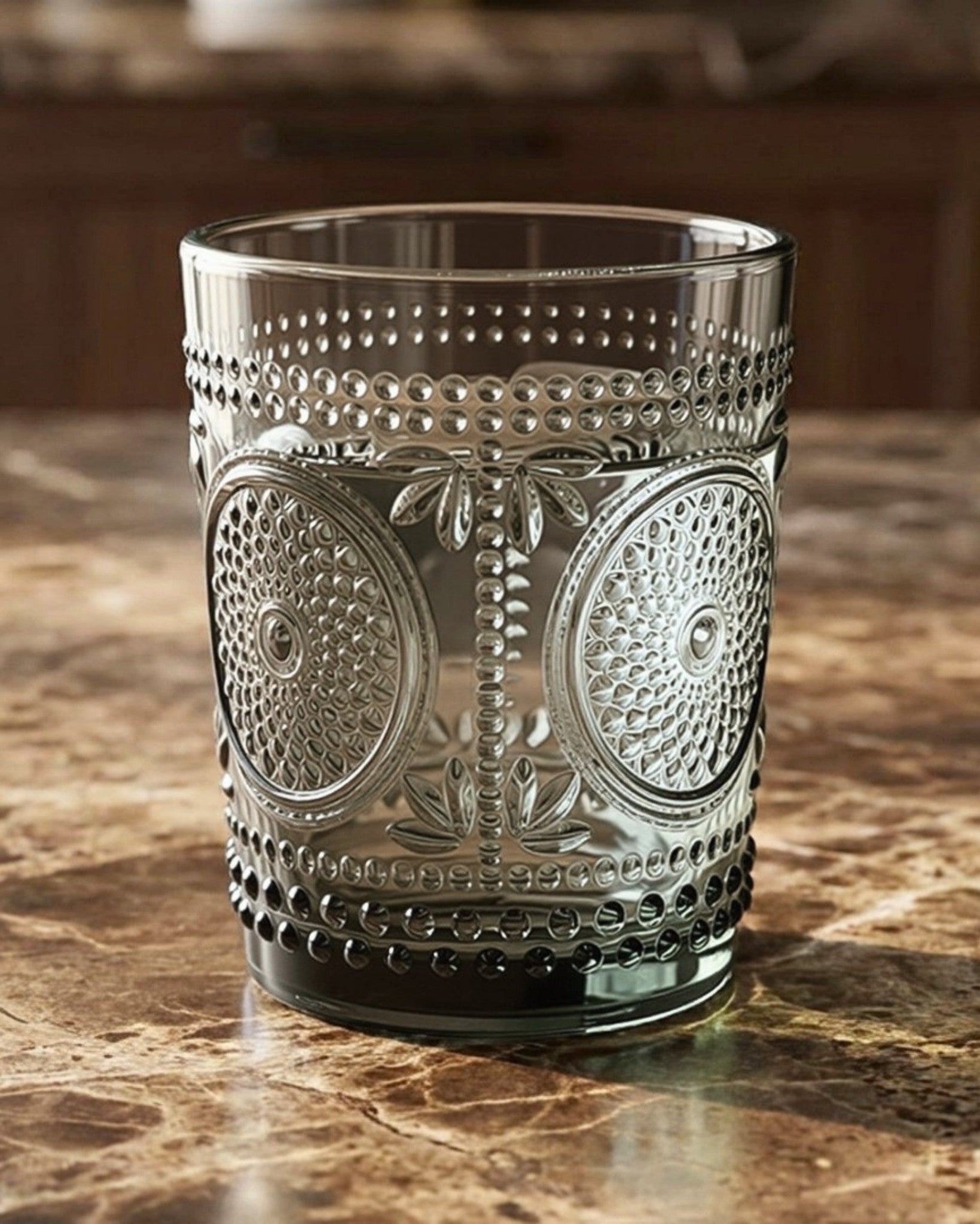 Set of textured glass tumblers on a white surface