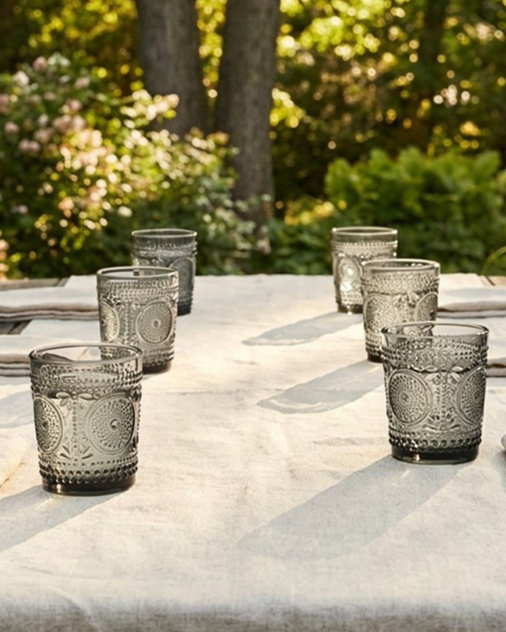 Set of textured glass tumblers on a white surface