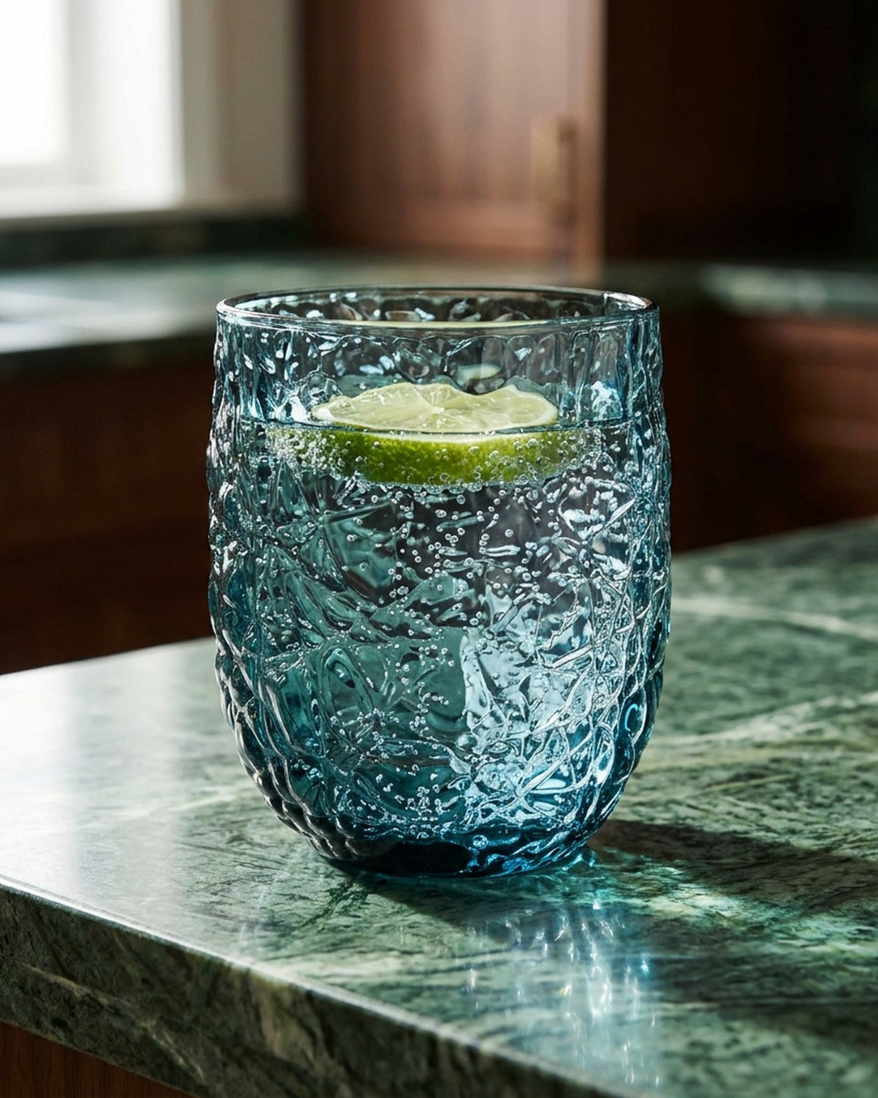 blue crackled glass on green marble surface