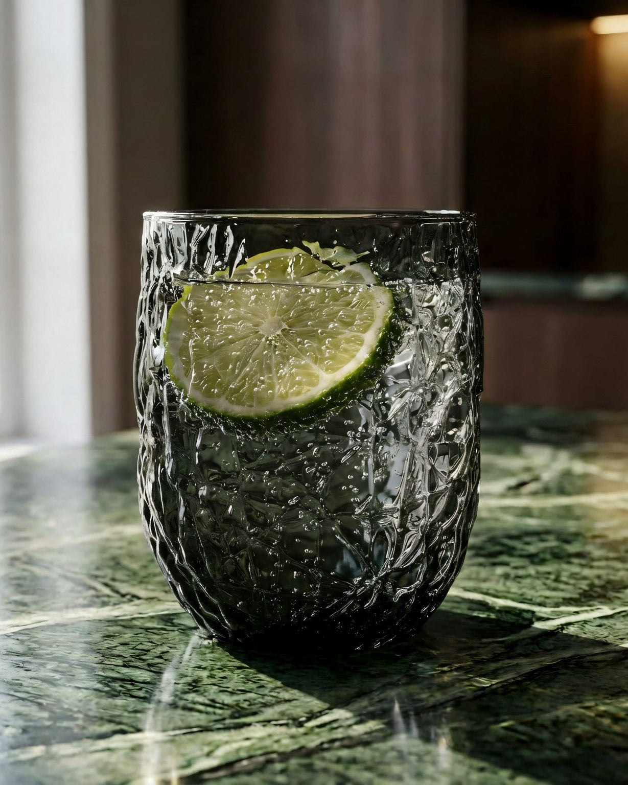 1 grey crumbled texture glass on green marble surface
