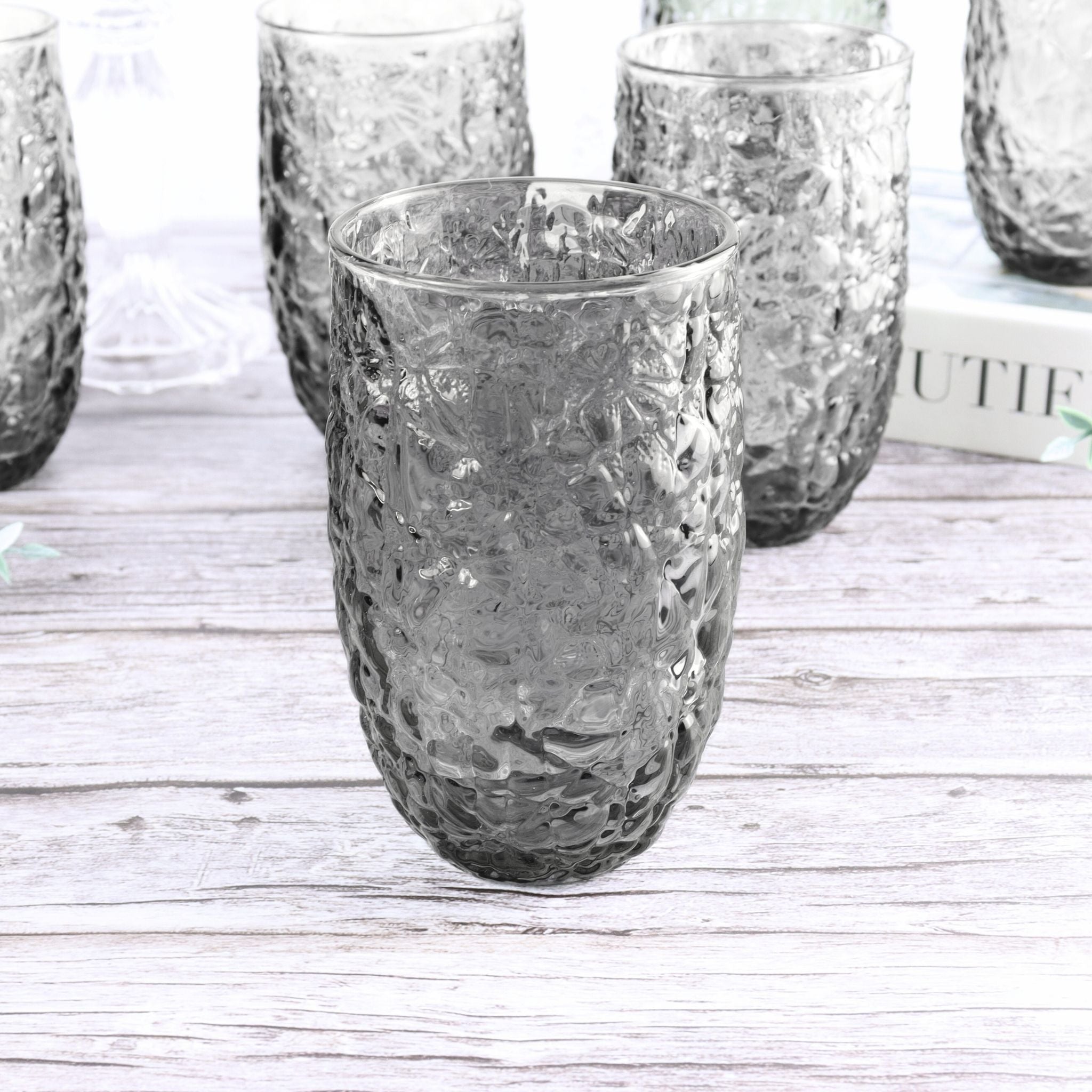 Set of textured glass tumblers on a wooden surface