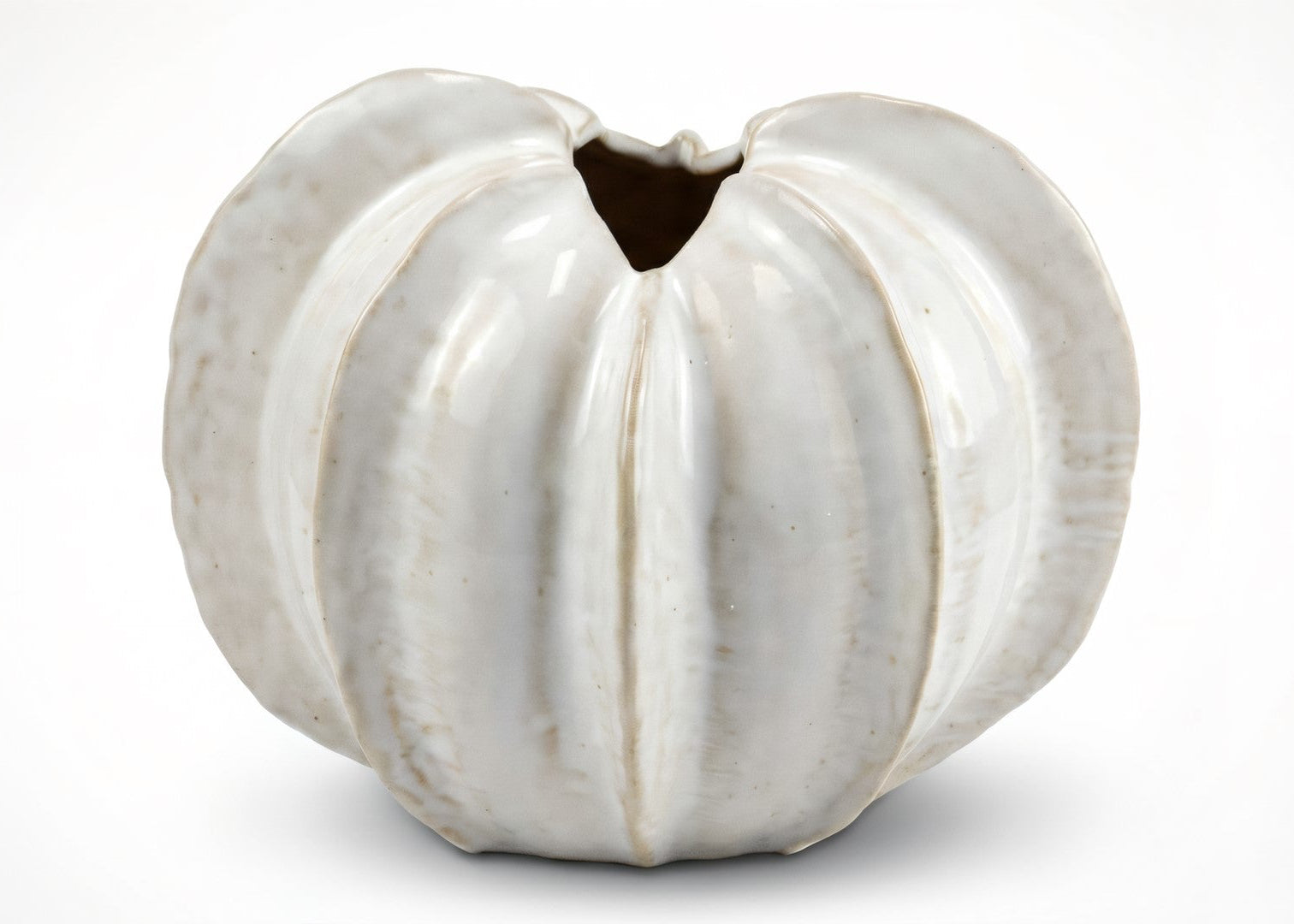 White ceramic vase with textured surface on a white background